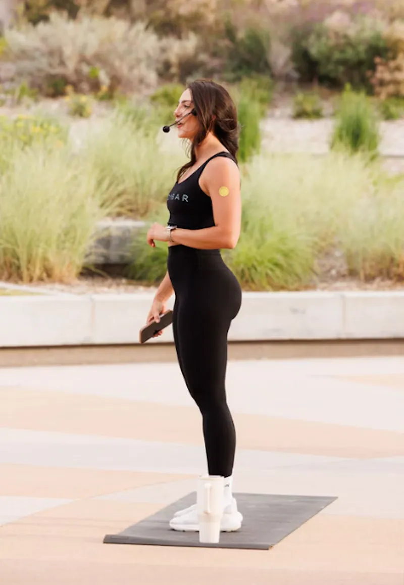 A host stretching outdoors at a wellness event