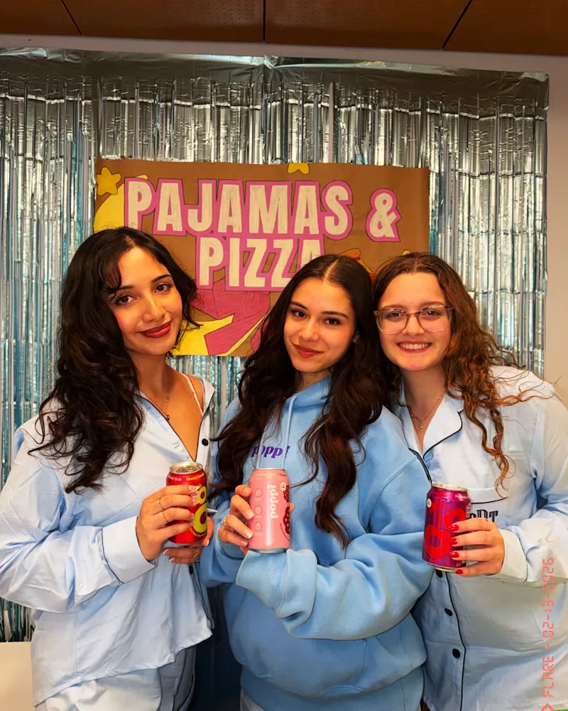 Guests with drinks at a pajama-themed event