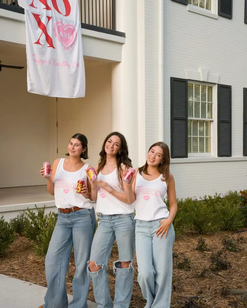 Guests with drinks outside a house event